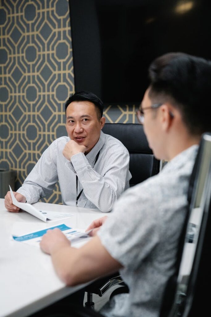 Two professionals engaged in a strategic meeting in a contemporary office setting.