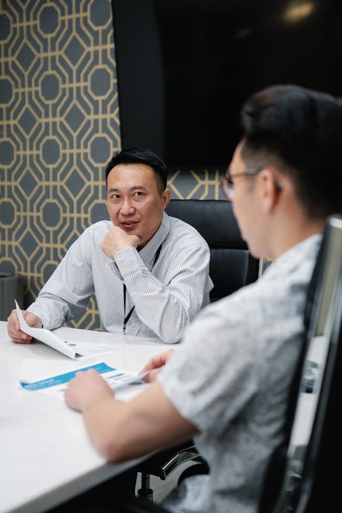 Two professionals engaged in a strategic meeting in a contemporary office setting.